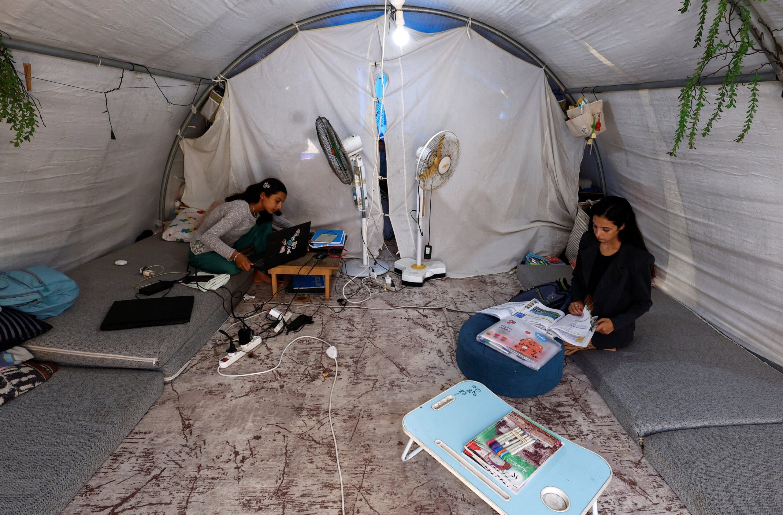 Palestinian student Raghad Loai Mhanna, who passed her high school exams while living in a tent after being displaced during the war, sits inside her tent in Deir al-Balah, central Gaza Strip, Oct.19, 2025. (Reuters Photo)