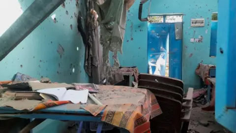 Reuters A desk bearing signs of shelling in a school where displaced people are sheltering, in el-Fasher